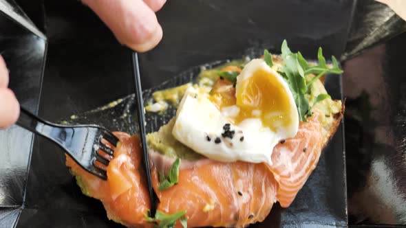 Sandwich with Salmon Egg on Top Cut with Knife and Fork