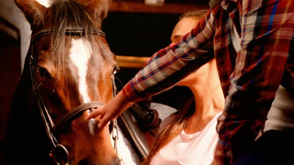 Mother and daughter petting a horse 4k