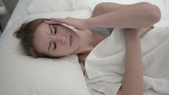 Sleepless Young Woman Having Headache in Bed