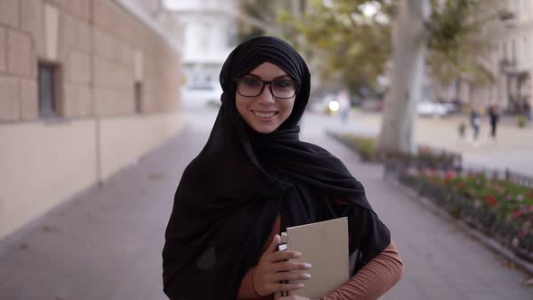 Portrait of a Pretty Muslim Woman in a Black Coloured Traditional Headscarf