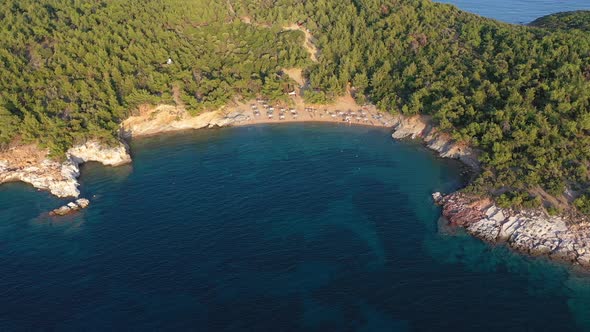 Aerial View of Beach Umbrellas and Sunbeds, Mediterranean Forest. Thassos island, Greece