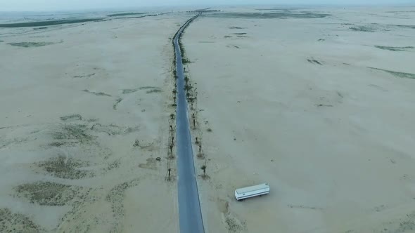 Flying With Drone Forward Blocked Road With Sands In Desert With Arabian desert in Dubai