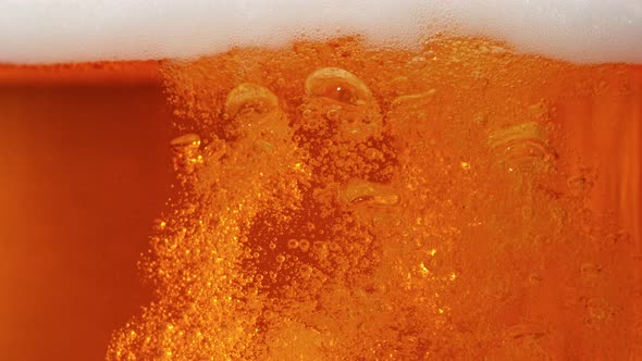 Super Slow Motion Shot of Rising Beer Bubbles and Fresh Foam Background at 1000Fps