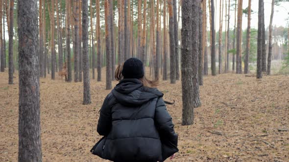 Frightened Teen Girl Running Away From Pursuit in the Forest Running Through the Trees