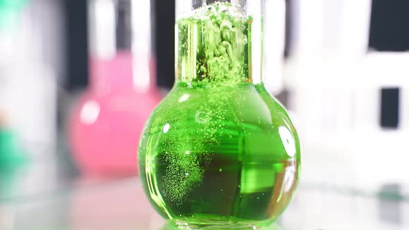 Flask Filled with Green Liquid in the Laboratory Closeup