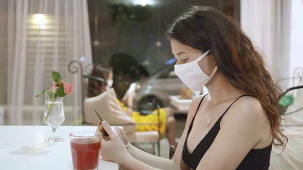 People in Medical Mask Sitting at the Table at Cafe or Restaurant