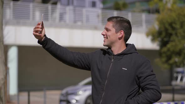 Happy Man Taking Selfie with Smartphone on Street