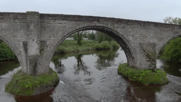 Slow motion, flying under Stirling Old Bridge in Scotland.