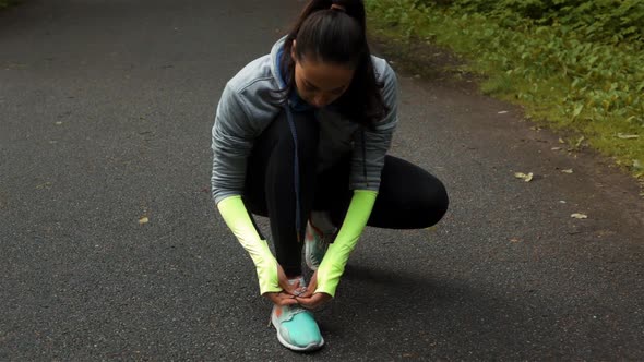 Woman Runner Tying the Shoelaces