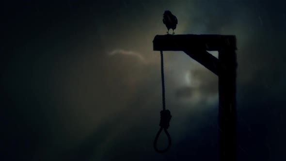 Raven Standing On A Gallows With A Swinging Noose In A Storm