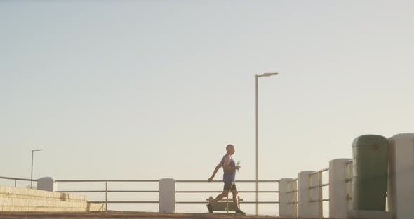 Senior man performing stretching exercise on the promenade