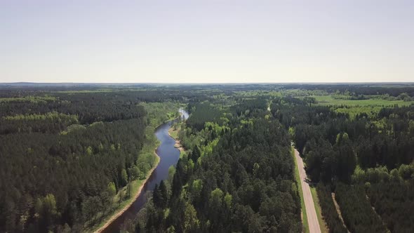 Beautiful Landscape of a Forest, River and Road in Summer Time