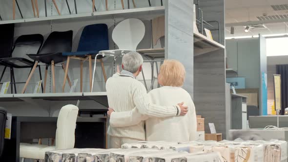 Rear View Shot of a Lovely Senior Couple Choosing Furniture Together at the Store