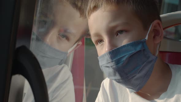 Tired boy wearing mask in the bus