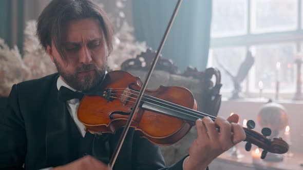 Man Plays Violin On Chair