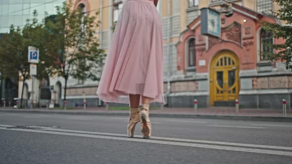 Ballerina in Pointe Shoes Steps on Road with Rumble Strips