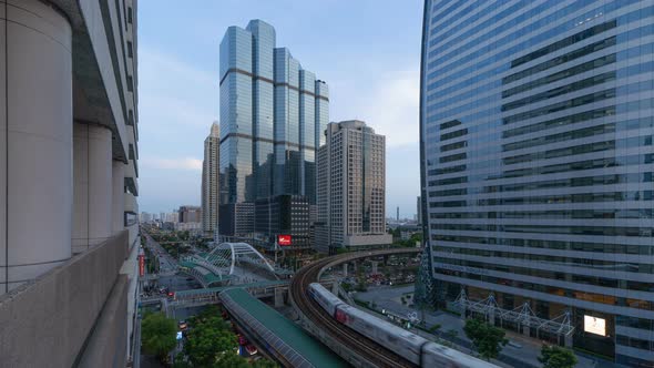 Day to night time lapse of Sathorn intersection, Bangkok Downtown, Thailand.