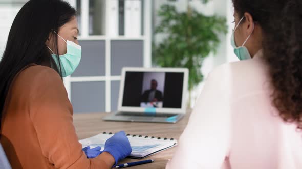 Handheld video of women during video conference with boss. Shot with RED helium camera in 8K.