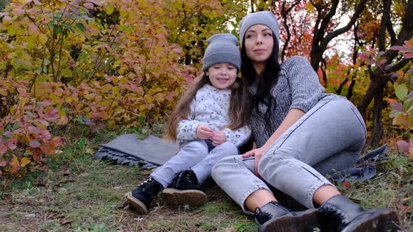 Mom and Threeyearold Daughter in the Park on a Picnic