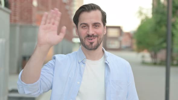 Welcoming Man Waving While Standing Outdoor