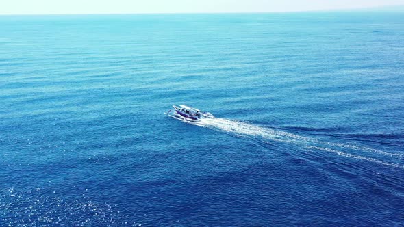 Aerial drone shot texture of idyllic sea view beach break by blue water with white sandy background 