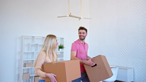 Romantic newlyweds with large brown cardboard boxes