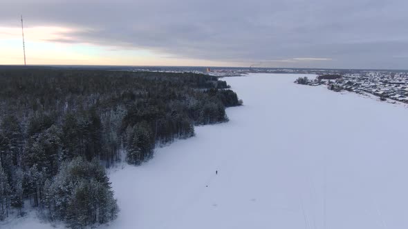 Flight Over a Taiga Forest Lake in Winter