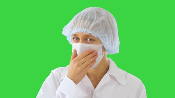 Coughing Female Doctor in a Mask To Prevent Others From Infection on a Green Screen, Chroma Key