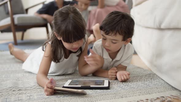 Cute Little Kids Lying on Floor in Living Room