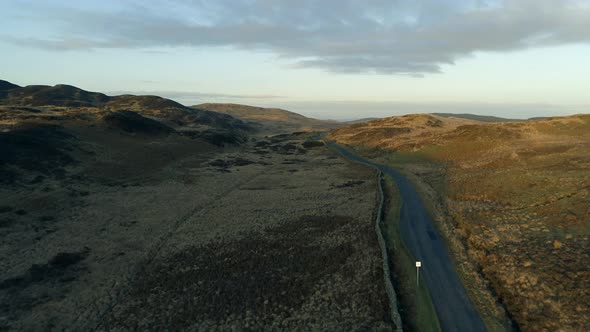 Road in Scotland With Old Rock Wall at Sunset