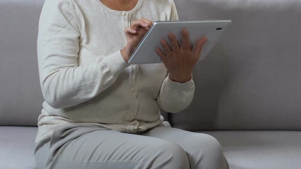 Middle-Aged Woman Surfing Web on Tablet, Shopping Online, Searching Discount