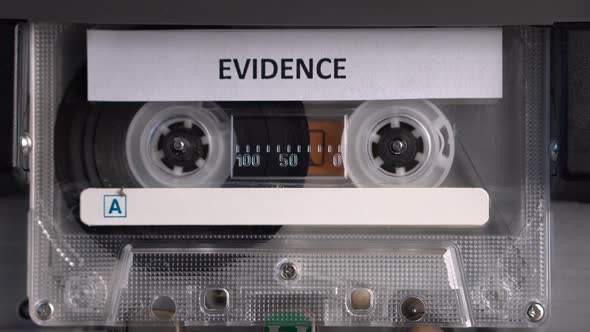 Audio Cassette Tape With Evidence Recording Rolling in Deck Player Close Up