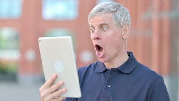 Outdoor Upset Middle Aged Man Get Shock on Tablet