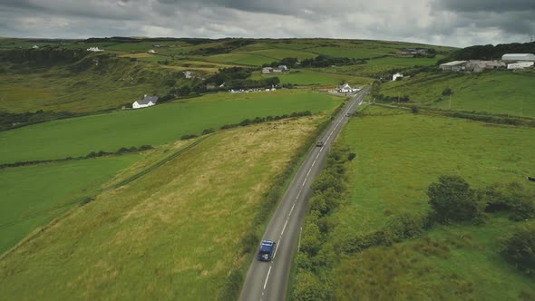 Aerial Ireland's Road View: Cars Riding on Countryside Green Way. Crossroads with Vehicles Moving