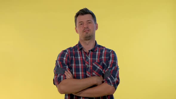 Tall Young Man Deriding Somebody Making Fun of Someone on Yellow Background