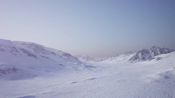 Aerial Landscape of Snowy Mountains and Icy Shores in Antarctica