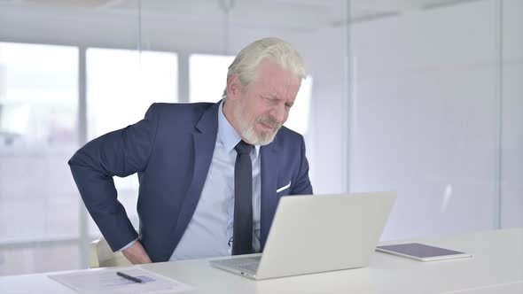 Tired Old Businessman with Back Pain at Work