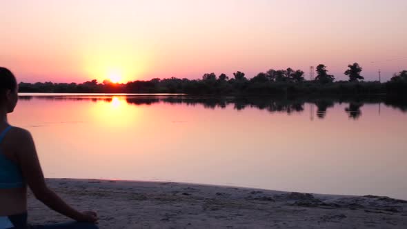 Girl Does Yoga and Looks at the Sunset