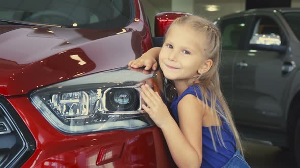 Beautiful Little Is Girl Posing on Car Background