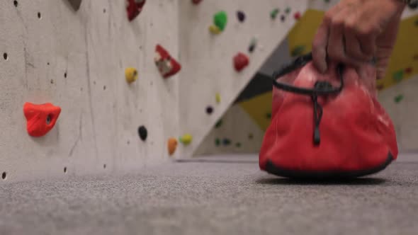 Close-up of a chalk bag in an indoor climbing gym.