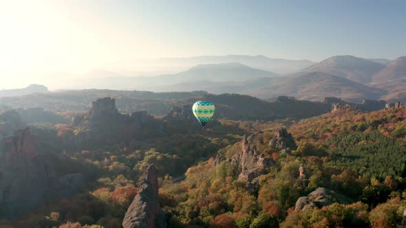 Hot air balloon over picturesque rock formation