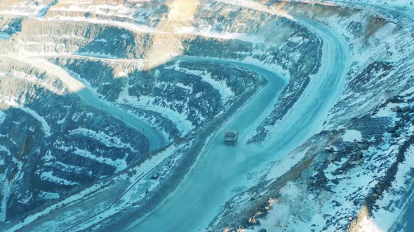 View From Above of a Truck Riding Through the Quarry