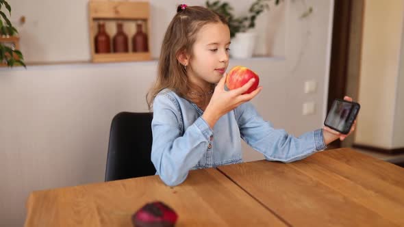 Happy Smiling Little Girl Holding Smartphone Having Video Call with Friend Distantly