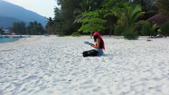 Ladies relaxing on relaxing island beach voyage by clear ocean and white sand background of Thailand