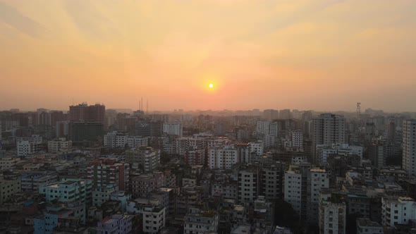 Developing country nation city air view during an intense orange sunset, Asia