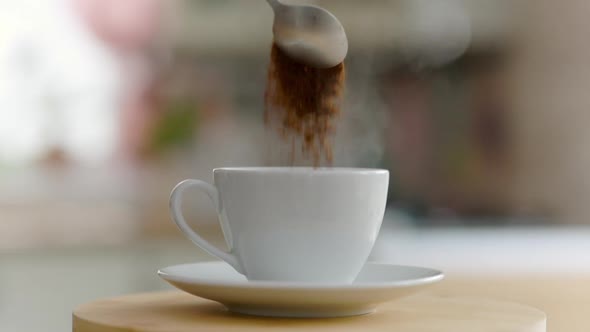 Coffee Pours Into A Cup From A Spoon And Steam Goes The Camera Moves