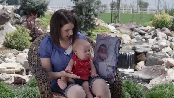 Slow motion of woman holding baby girl and picture of her in the hospital.