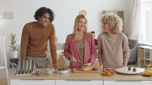 Two Diverse Women and Man Cooking Festive Dinner