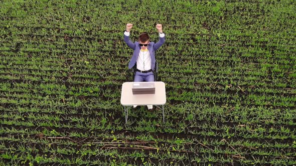 Aerial Top View of Freelancer Working By Laptop on Spring Meadow