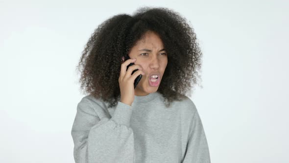 African Woman Angry on Smartphone, White Background 